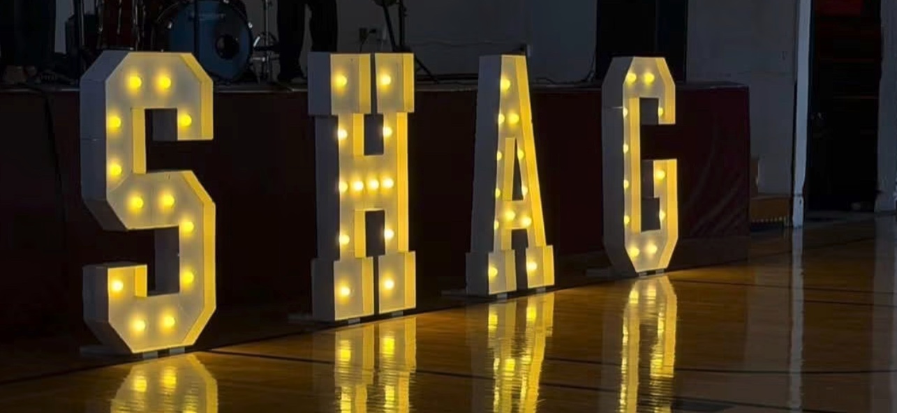 Illuminated marquee letters spelling SHAG on the dance floor at a The Schnauzer Salon event